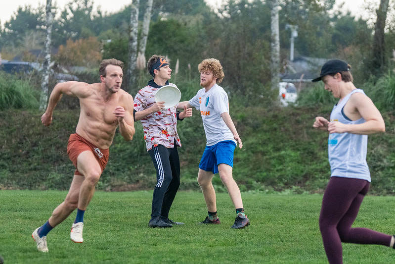 Players sprinting after a disc at Humboldt Harvest