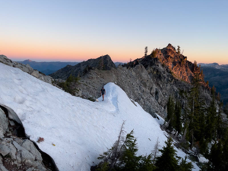 Snow-covered ridge glowing at sunset